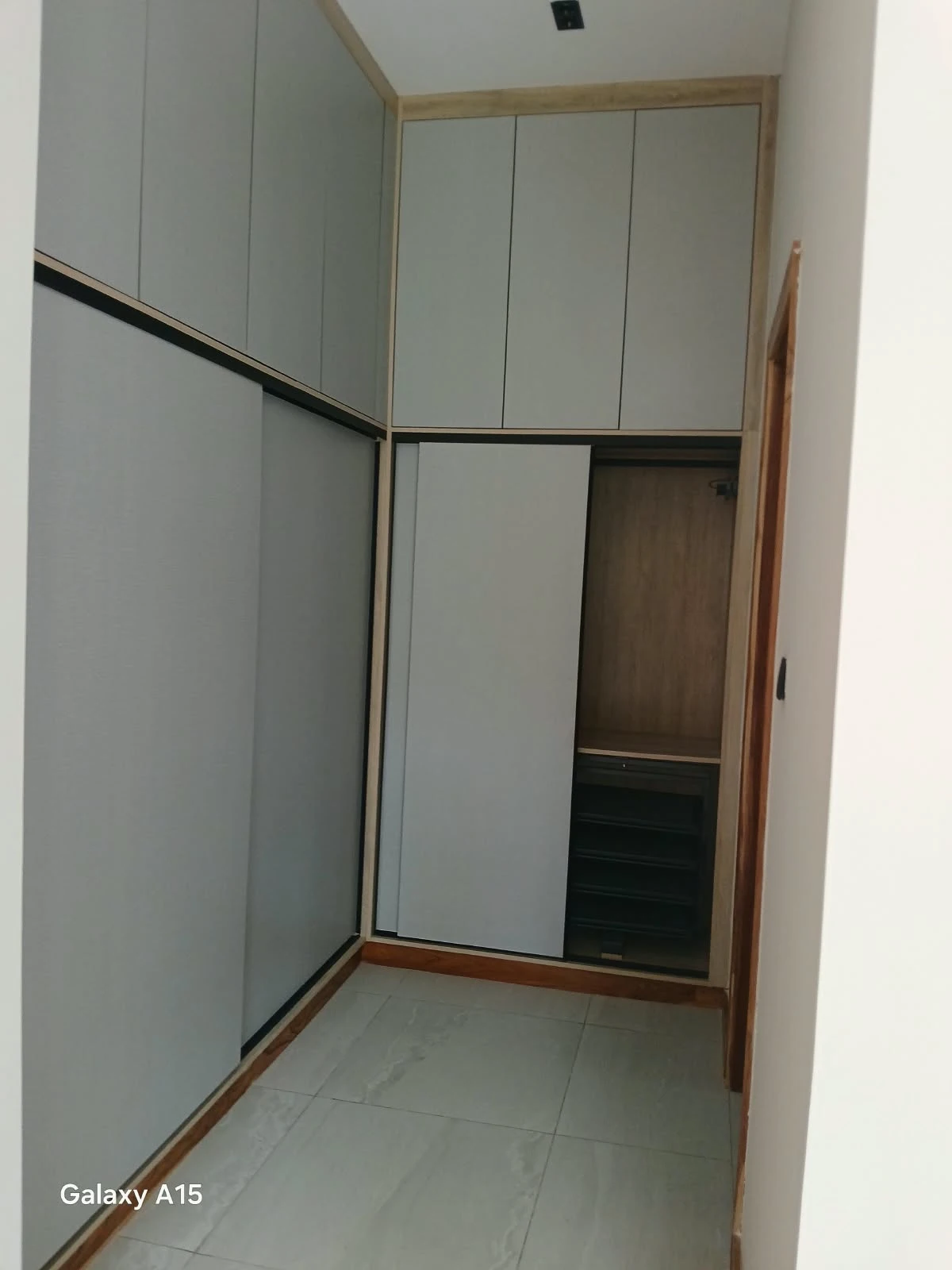 Full-height pale fitted wardrobe with contrasting trim
