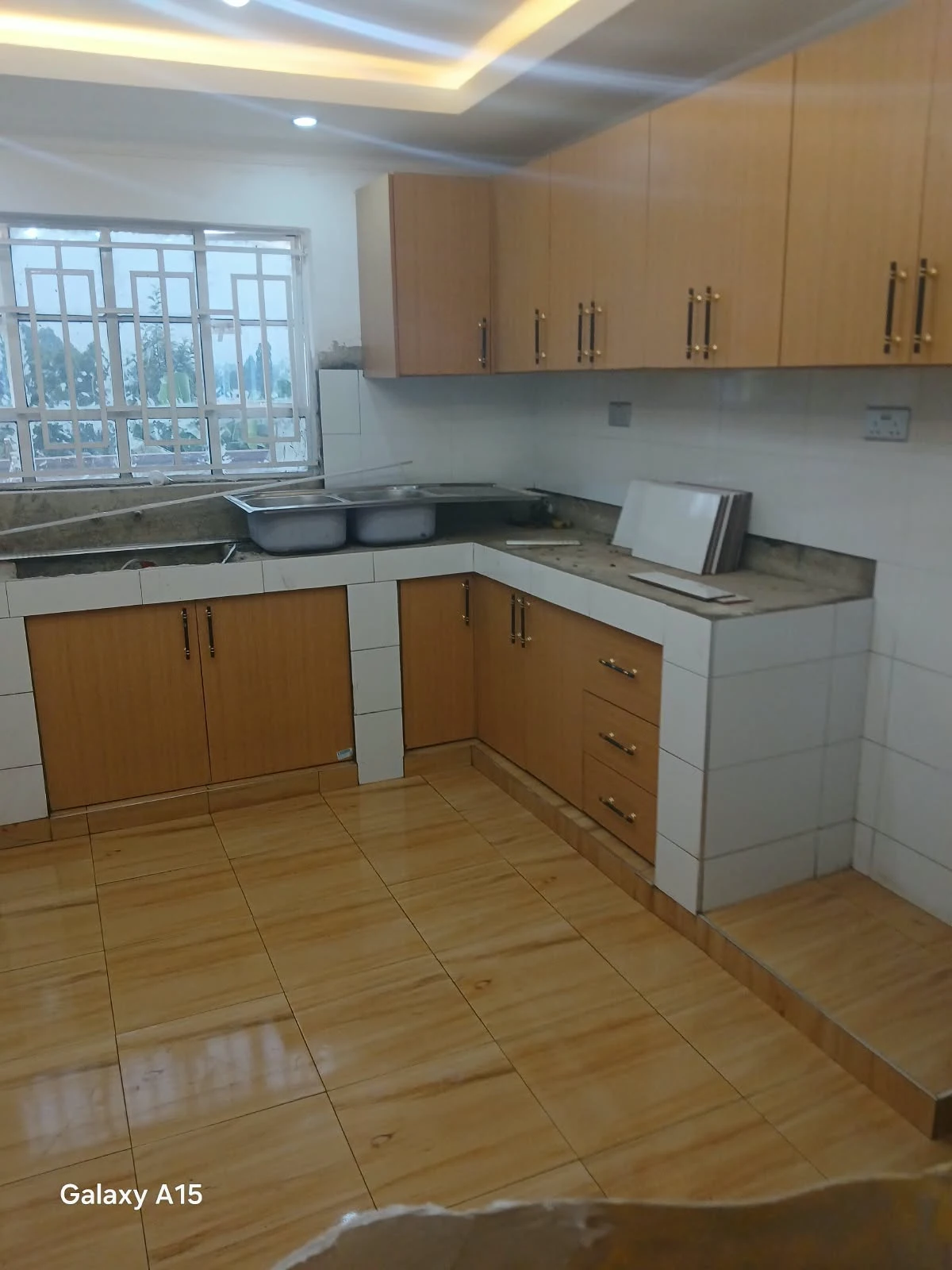 Wood-toned fitted kitchen cabinets